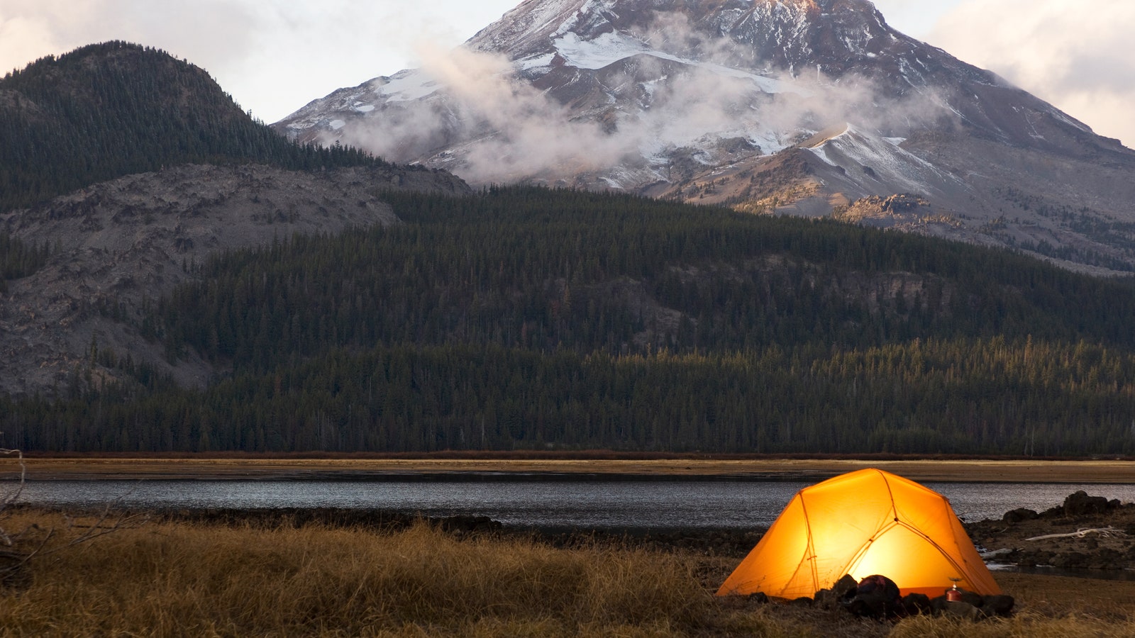 USA Oregon Bend illuminated tent by lake in mountains